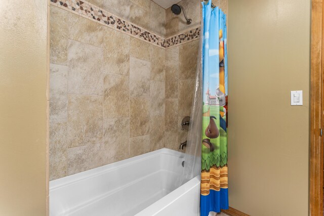 bathroom with shower / tub combo with curtain