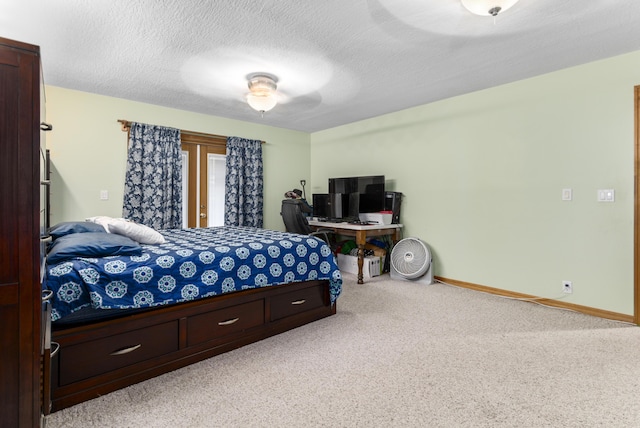 bedroom with ceiling fan, carpet, and a textured ceiling