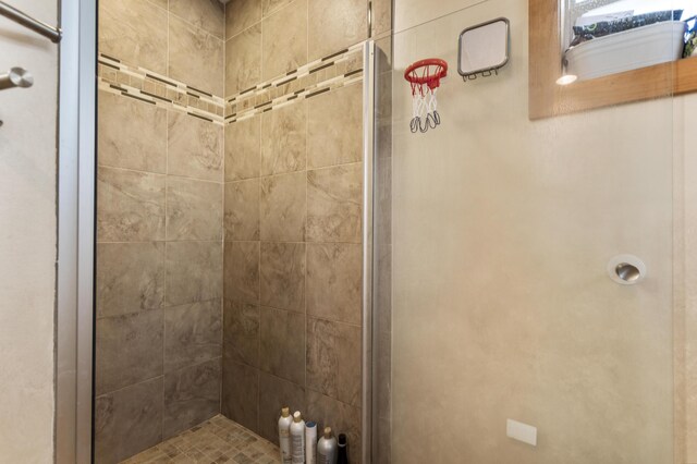 bathroom featuring a shower with door