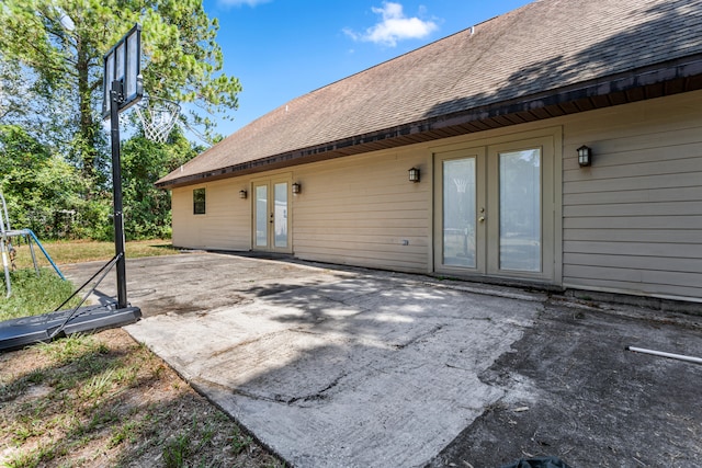 back of property with a patio, french doors, and a playground