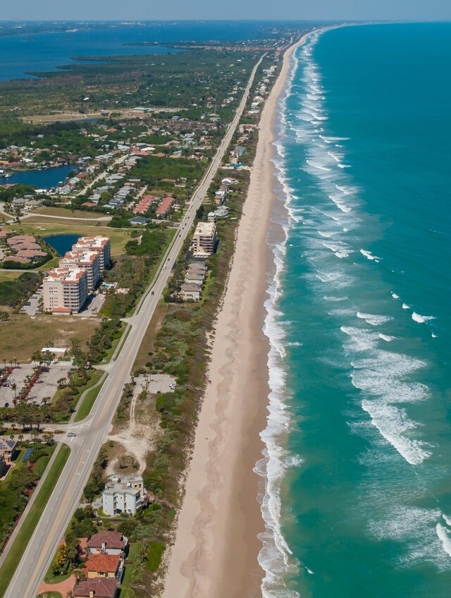 drone / aerial view with a view of the beach and a water view