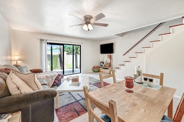 living room with light tile flooring, ceiling fan, and a textured ceiling