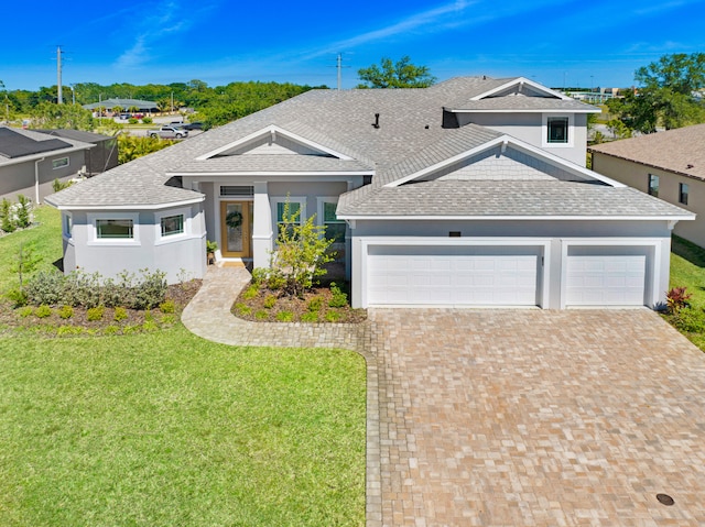 view of front of house featuring a garage and a front lawn