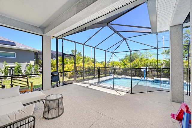 view of swimming pool featuring glass enclosure and a patio area