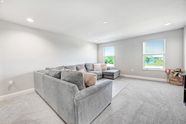 living room featuring light carpet and a textured ceiling