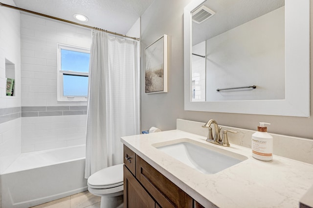 full bathroom featuring a textured ceiling, tile flooring, shower / bath combination with curtain, vanity, and toilet