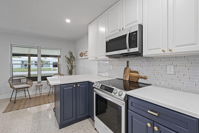 kitchen with kitchen peninsula, backsplash, blue cabinets, electric stove, and white cabinets