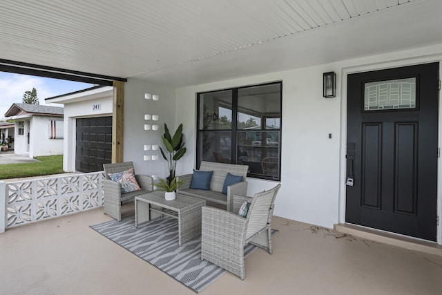 view of patio / terrace featuring outdoor lounge area and a garage