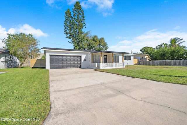 ranch-style home featuring a garage and a front lawn