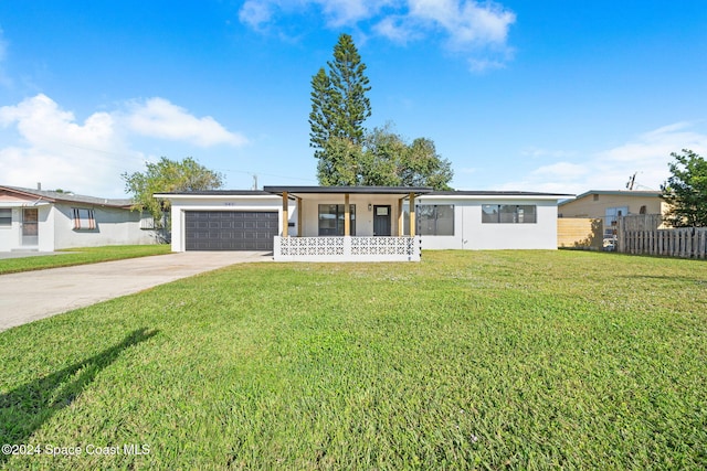 ranch-style house featuring a front lawn, a porch, and a garage