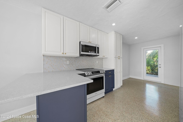 kitchen featuring white cabinets, decorative backsplash, blue cabinetry, appliances with stainless steel finishes, and kitchen peninsula