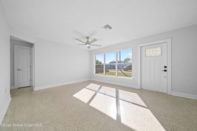 unfurnished living room featuring ceiling fan