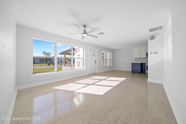 unfurnished living room with ceiling fan