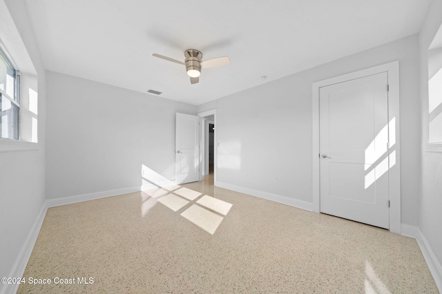 unfurnished bedroom featuring ceiling fan