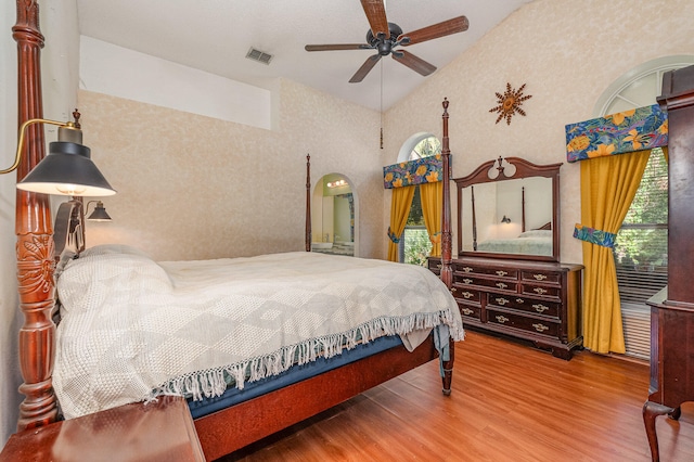 bedroom featuring high vaulted ceiling, ceiling fan, and hardwood / wood-style flooring