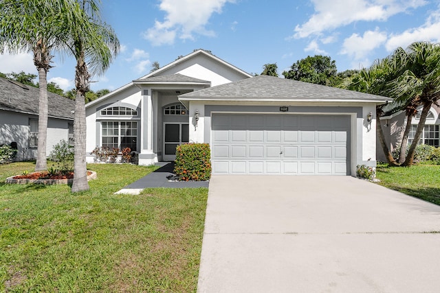 view of front of home featuring a garage and a front lawn