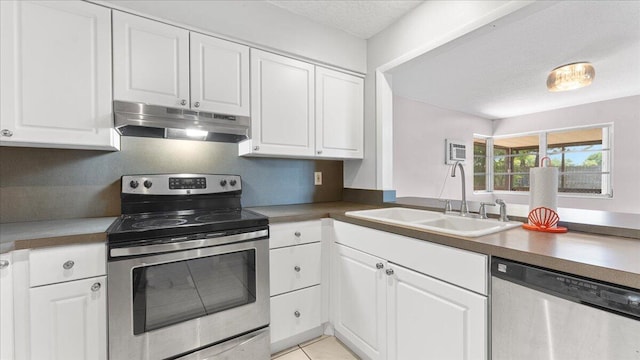 kitchen with white cabinetry, sink, stainless steel appliances, and a textured ceiling