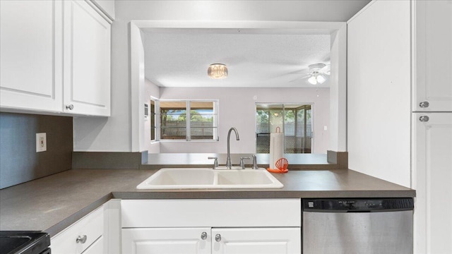 kitchen featuring white cabinets, a textured ceiling, stainless steel dishwasher, and sink