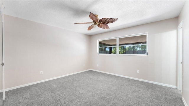 carpeted empty room featuring a textured ceiling and ceiling fan