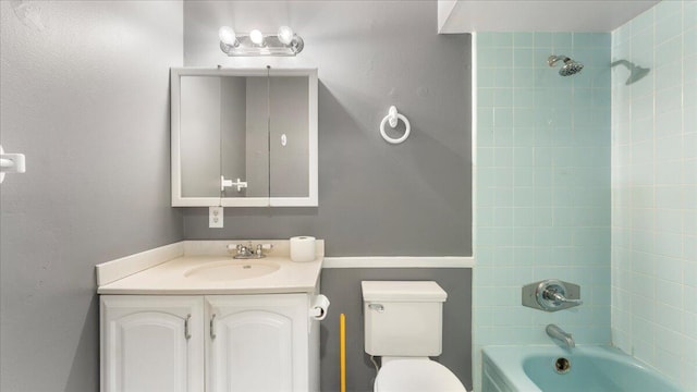 full bathroom featuring toilet, vanity, and tiled shower / bath