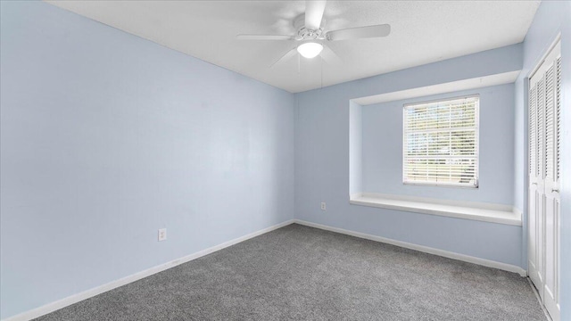 empty room featuring carpet flooring and ceiling fan