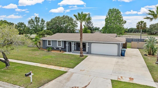 ranch-style house featuring a front lawn and a garage