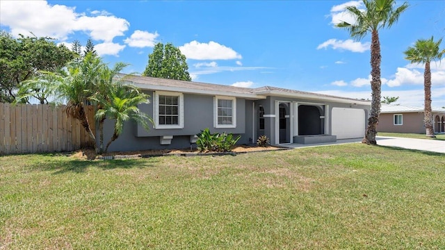 ranch-style house featuring a front lawn and a garage