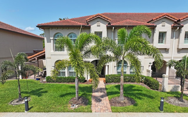 mediterranean / spanish-style home featuring a front lawn