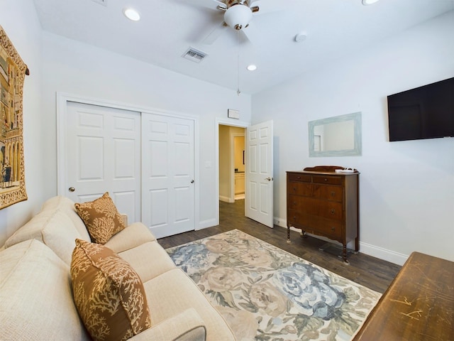 living room with dark hardwood / wood-style floors and ceiling fan