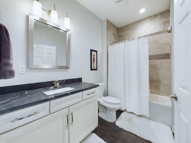 full bathroom featuring wood-type flooring, shower / bath combination with curtain, vanity, and toilet