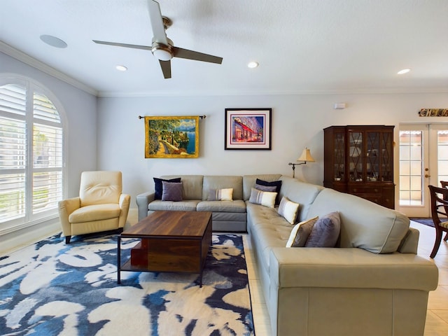 living room with french doors, ornamental molding, and ceiling fan