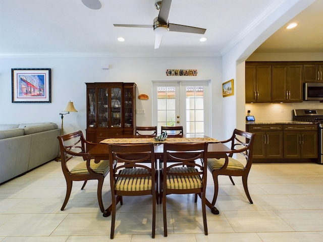 dining area with french doors, ornamental molding, light tile flooring, and ceiling fan