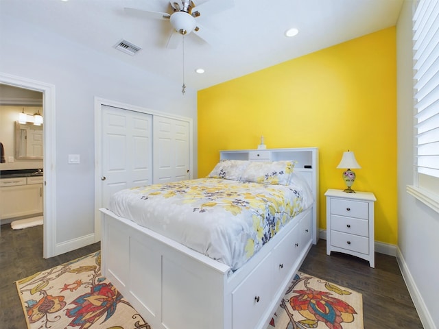 bedroom with dark wood-type flooring, a closet, and ceiling fan