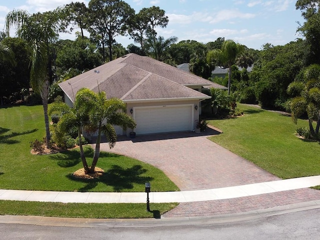 view of front facade with a garage and a front lawn