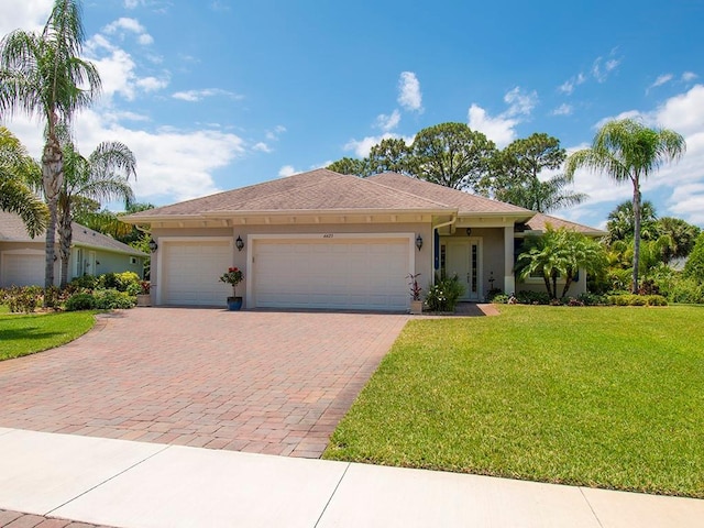 view of front facade featuring a front yard and a garage