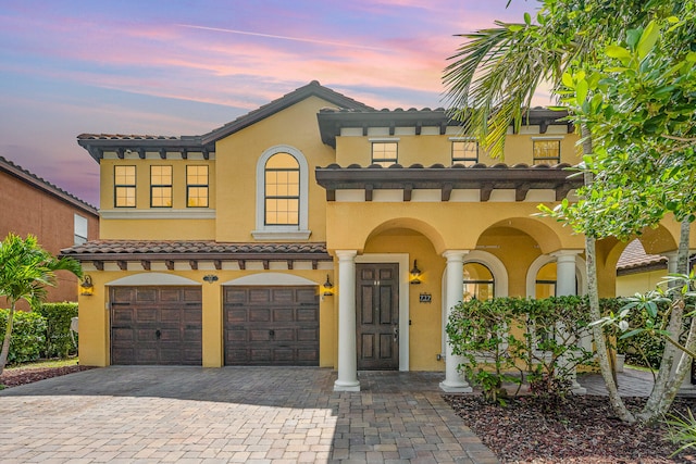 mediterranean / spanish house featuring a garage