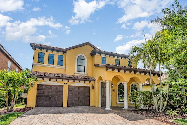 mediterranean / spanish-style home with a garage