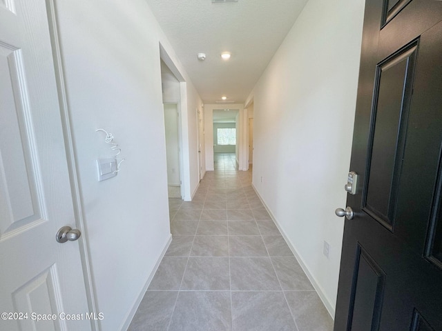 corridor with light tile patterned floors