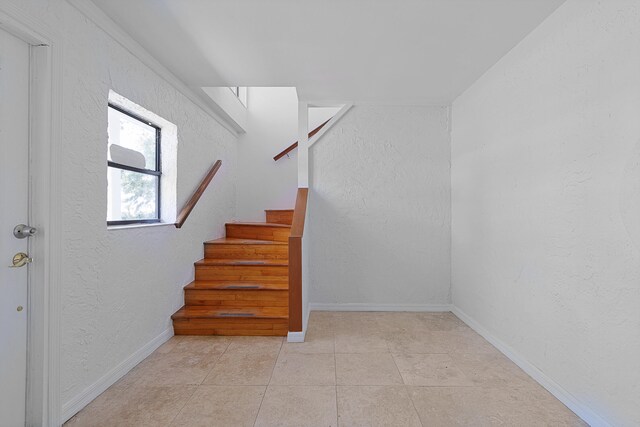 stairway with light tile floors