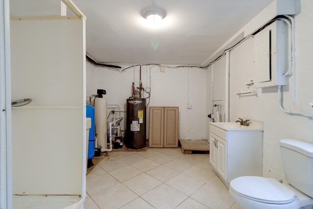 bathroom featuring tile floors, water heater, a shower, vanity, and toilet