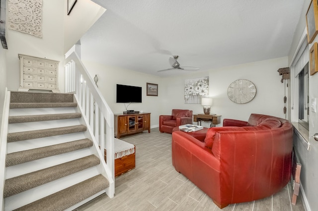 living room featuring ceiling fan and light wood-type flooring