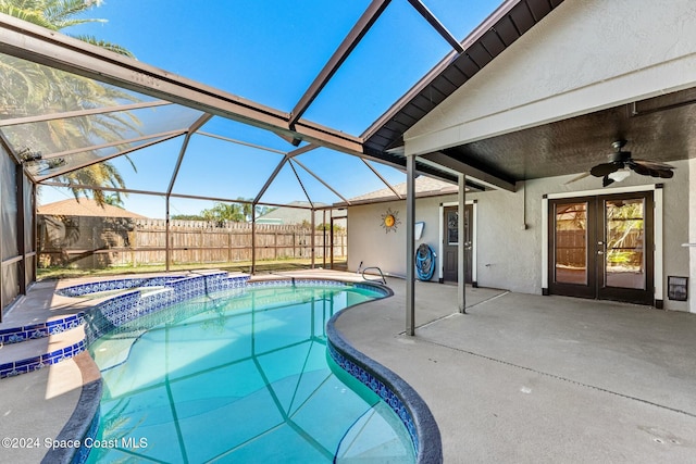 view of pool featuring ceiling fan, french doors, a lanai, a patio area, and an in ground hot tub