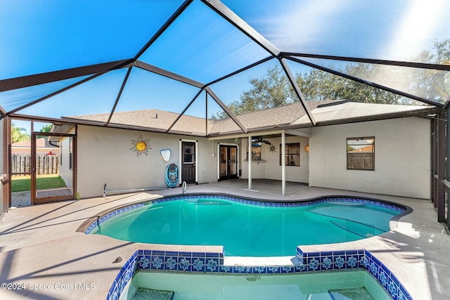 view of swimming pool with a lanai, a patio area, and ceiling fan