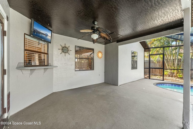 view of patio / terrace featuring ceiling fan and a lanai