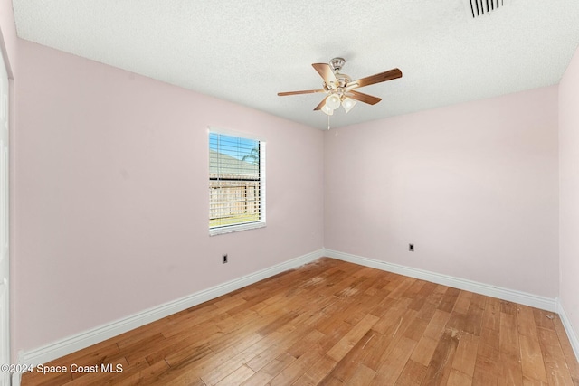 unfurnished room with hardwood / wood-style floors, a textured ceiling, and ceiling fan