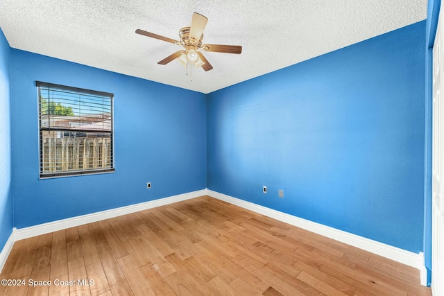 spare room featuring hardwood / wood-style floors, ceiling fan, and a textured ceiling