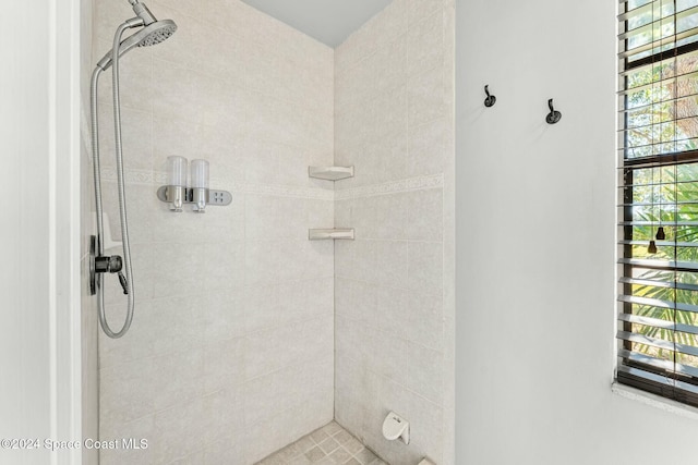 bathroom with a tile shower