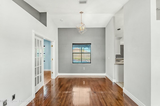 unfurnished dining area with french doors and dark hardwood / wood-style floors