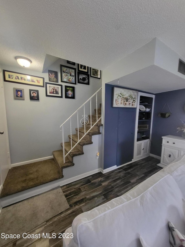 interior space featuring dark hardwood / wood-style floors and a textured ceiling