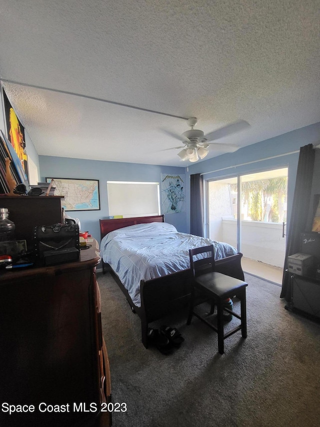 carpeted bedroom featuring ceiling fan and a textured ceiling